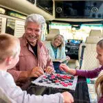 family playing checkers in ultimate RV cabin